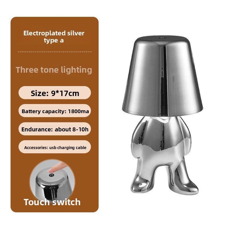 Tischlampe mit goldfarbener Figur