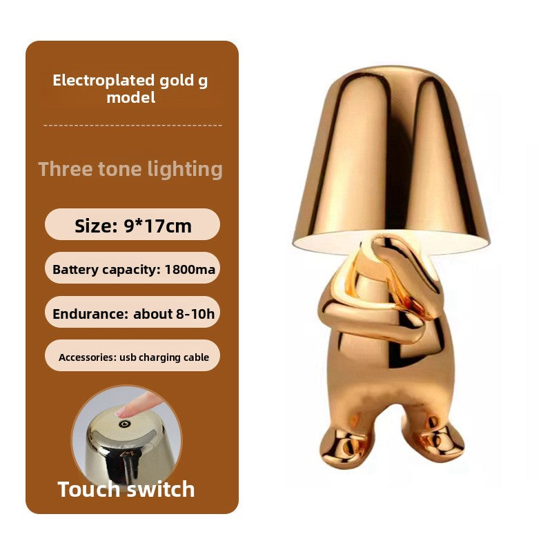 Tischlampe mit goldfarbener Figur