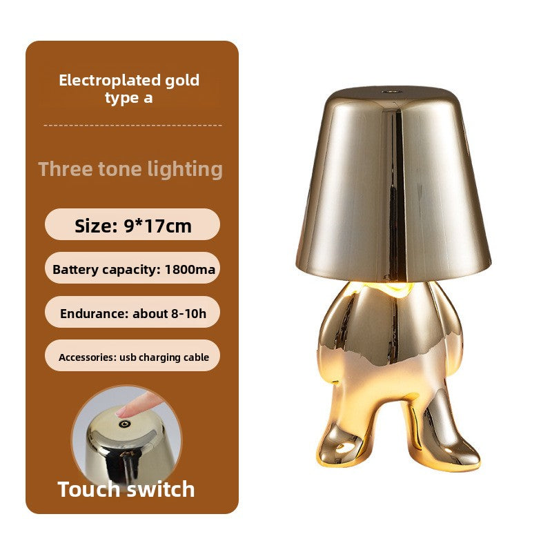Tischlampe mit goldfarbener Figur
