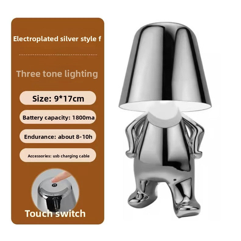 Tischlampe mit goldfarbener Figur