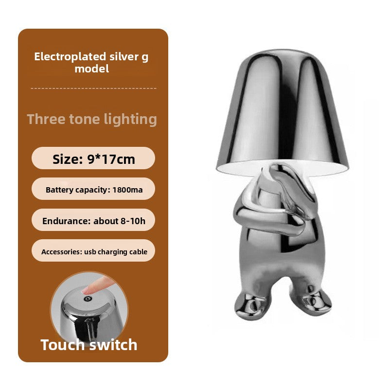 Tischlampe mit goldfarbener Figur
