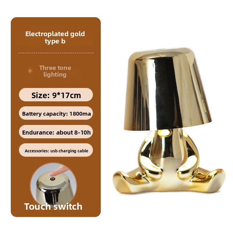 Tischlampe mit goldfarbener Figur